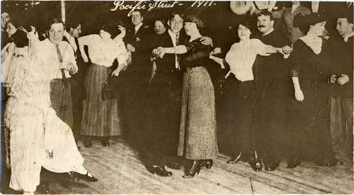 [People dancing inside Spider Kelly's bar room on Pacific Street in the Barbary Coast district]