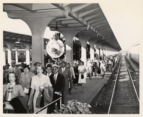 [Commuters on platform at Southern Pacific terminal]