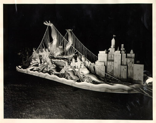 [Golden Gate Bridge Fiesta Parade float featuring women dressed up as mermaids surrounding a sculpture of Neptune]