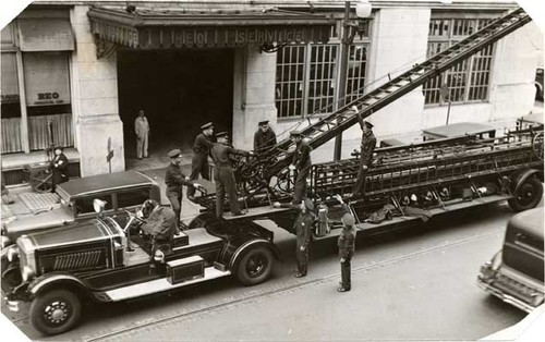 [Group of firemen with an old aerial ladder truck at Engine 3]