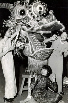 [Three women posing with Chinese dragon]