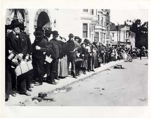 [Refugees standing in a bread line on Clayton Street]