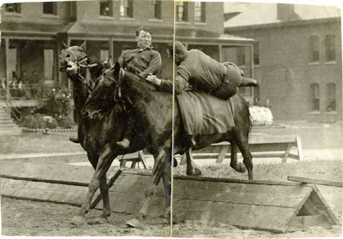 [Two soldiers riding horses at the Presidio]