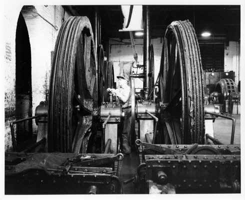 [Unidentified man working in the cable car barn at California and Hyde Streets]