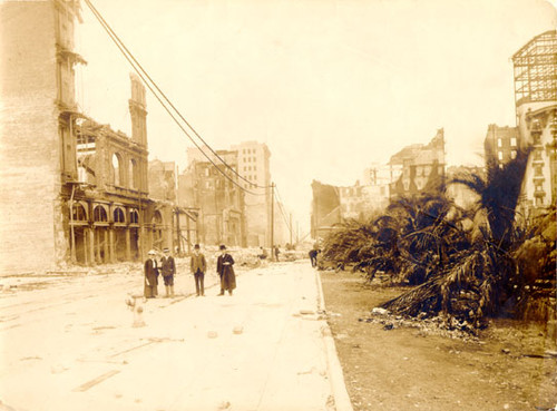 [Four people standing on Post Street, next to Union Square Park, after the earthquake and fire of April, 1906]