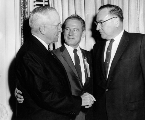 [Edmund G. (Pat) Brown (right) shakes hands with former President Harry S.Truman with Claire Engle in the middle]