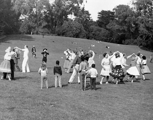 [People dancing on a field during the Golden Gate Park Centennial Parade]