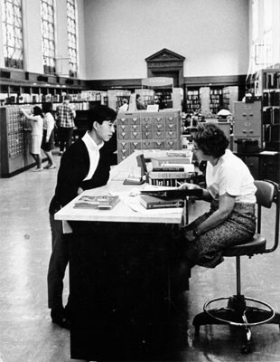 [Librarian helping a patron in the Literature Department at the Main Library]