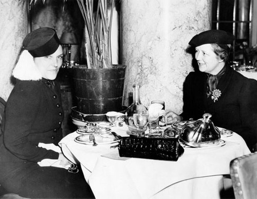 [Mrs. Joseph C. Hickingbotham and Mrs. Charles Sweet having lunch in the Palm Court of the Palace Hotel]