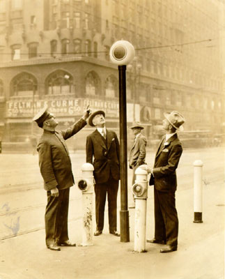 [Three men standing together on Market Street]