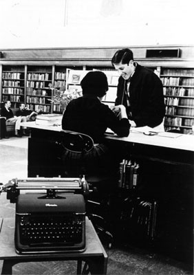 [Librarian helping a patron in the Literature Department at the Main Library]