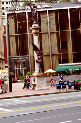 [The miner from the Native Sons Statue with portions of his body and flag doused with red paint]