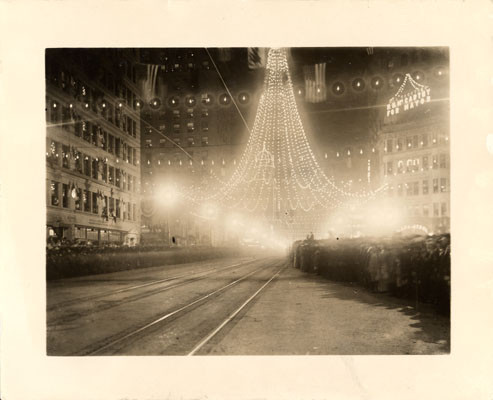 [Intersection of Market and Third streets, where 25,000 colored lights were suspended to form a gigantic bell, Portola Festival, October 19-23, 1909]