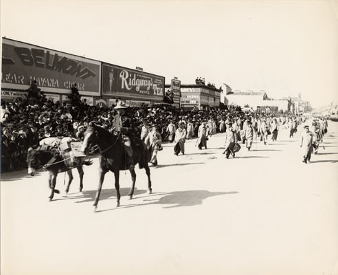 [Man on horseback preceding a group of costumed men on foot, Parade from Portola Festival, October 19-23, 1909]