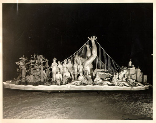 [Golden Gate Bridge Fiesta Parade float featuring women dressed up as mermaids surrounding a sculpture of Neptune]