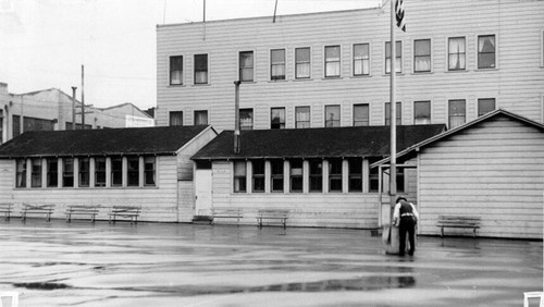 [Unidentified man in schoolyard of John Swett School]