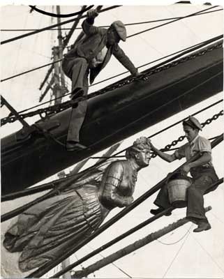 [Two men washing the figurehead on the sailing ship "Pacific Queen" (also known as the "Balclutha")]