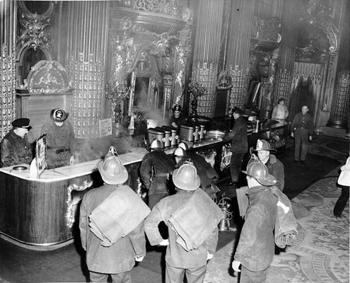 [Firemen in snack bar of Fox Theater after fire]
