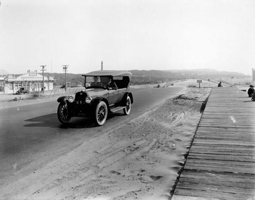 [Two men sitting in a car at Great Highway and Sloat Boulevard]