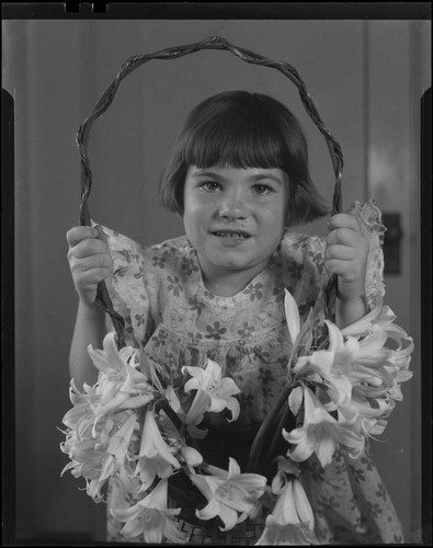Girl with basket of Easter lilies, Los Angeles, circa 1935