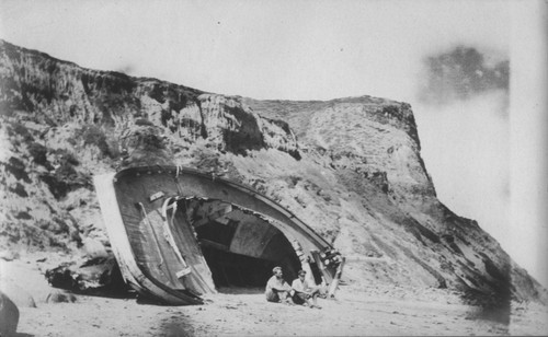 The "Loma" given to the Marine Biological Association of San Diego by E.W. Scripps for research purposes showed here run aground near the Point Loma lighthouse on July 25, 1906. The boat was caught by the breakers and carried up onto the rocky ledge that juts out from the point. When she could not be rescued everything was taken off the boat, including the copper sheathing and four tons of lead from the keel and she was abandon. The Association became the Scripps Institution of Oceanography. July 25,1906