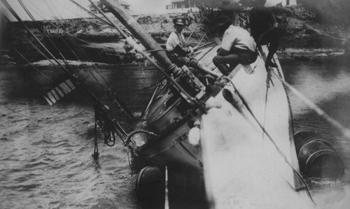 Men working on the salvage of the wreck of the "Loma" given to the Marine Biological Association of San Diego by E.W. Scripps for research purposes; it ran aground near the lighthouse on Point Loma on July 25, 1906. The Association became the Scripps Institution of Oceanography. July 25, 1906