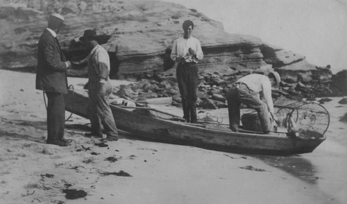 Wesley Clarence Crandall (far left) shown here with Robert H. Baker and two other men at La Jolla Cove. Crandall was the Secretary of the Marine Biological Association of San Diego, which became Scripps Institution of Oceanography. Circa 1906