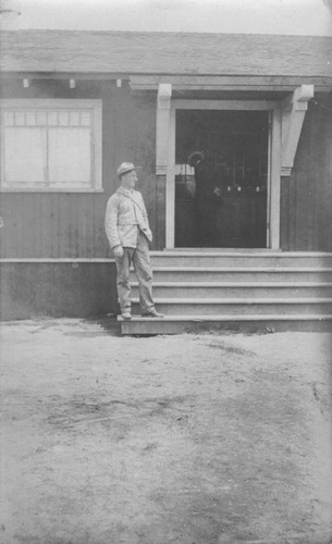 Man on the steps of the Marine Biological Association of San Diego building at La Jolla Cove. The Association became the Scripps Institution of Oceanography. Circa 1905