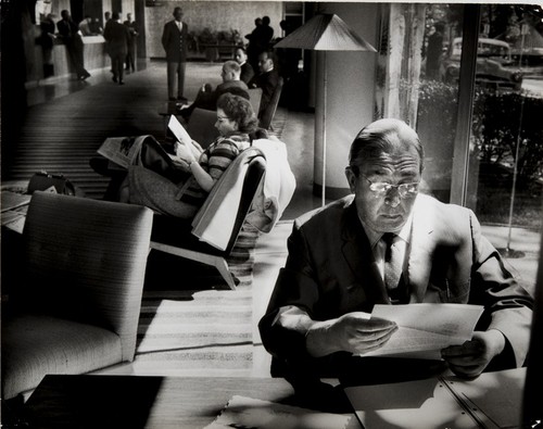 Portrait: Leo Szilard reading at desk in the Dupont Plaza Hotel lobby; Washington, DC