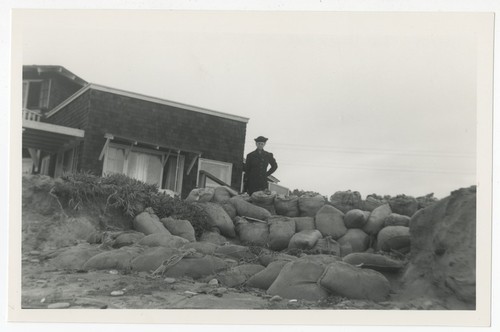 Mary Fletcher at Heyer House with sandbag wall