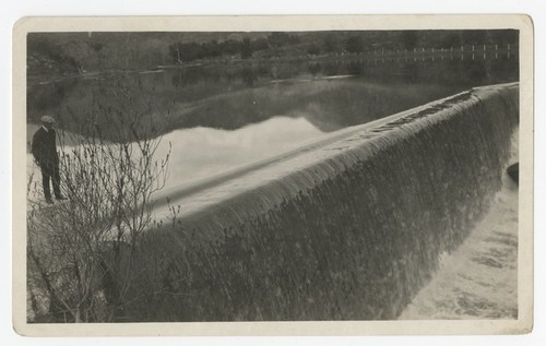 Man standing above spillway at Boulder Creek diverting dam