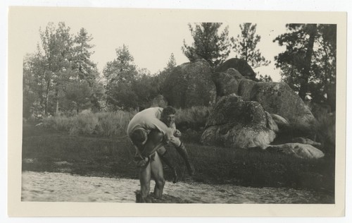 Fletcher son carrying another man across river, Baja California