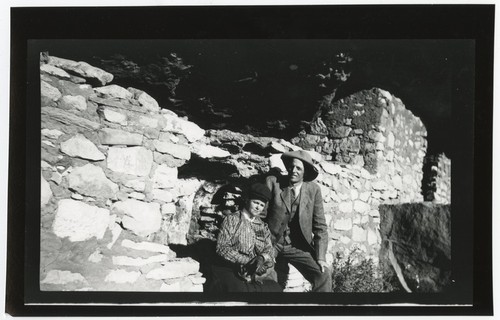 Ed and Mary Catherine Fletcher, seated near an old stone wall