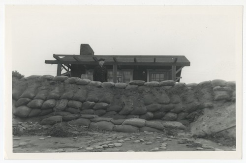 Mary Fletcher at Heyer House with sandbag wall