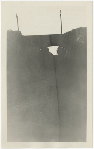 Man surveying a break in the dam at Torrey Pines