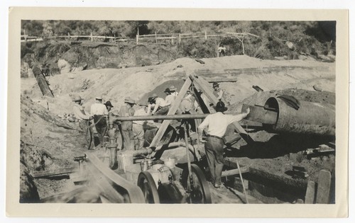 Laying steel pipe for repairs to the San Diego flume following the 1916 flood