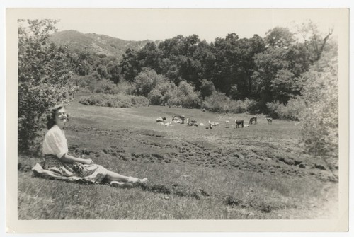 Mary Catherine Taylor in meadow with cows at Eagle's Nest