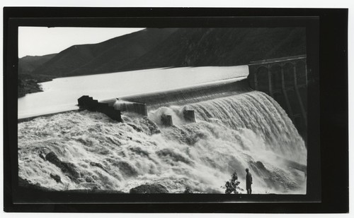 Ed Fletcher standing at Lake Hodges Dam with spillway overflow