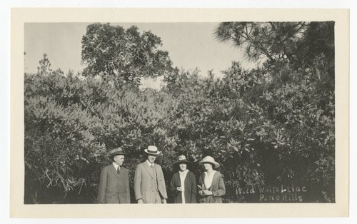 People in front of lilac bushes, Pine Hills