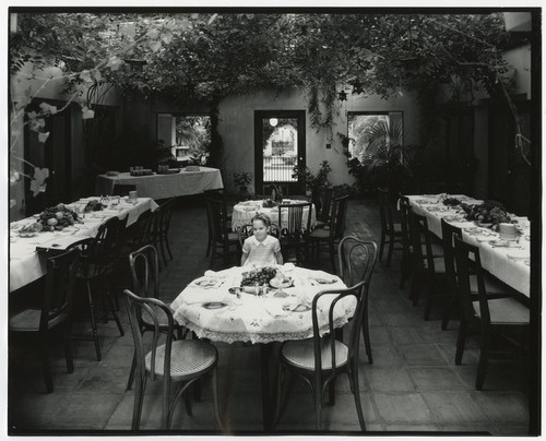 Girl in courtyard of Fletcher home on 4th and Walnut, San Diego