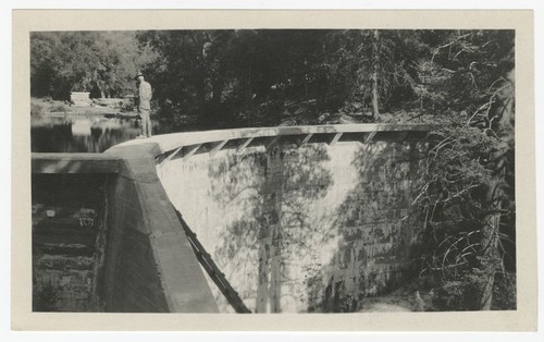 Man standing on edge of Eagle's Nest Dam, San Diego County