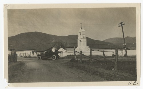 Men in front of the bell tower at Pala Mission