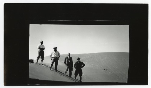 Men on sand dune