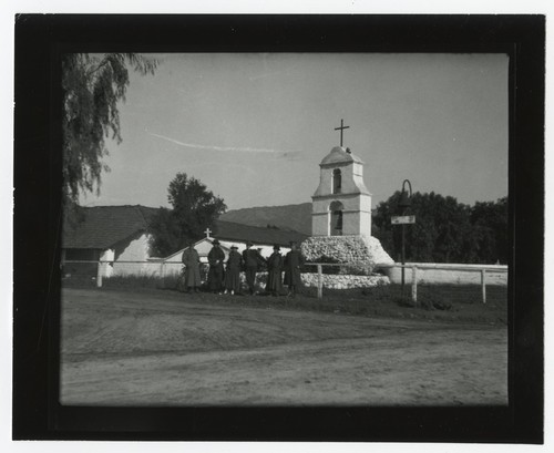 People in front of the bell tower at Pala Mission