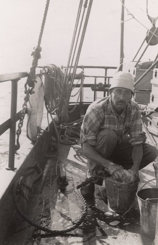 [Man washing in bucket R/V E.W. Scripps]