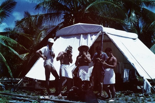 Scientists eating lunch at Bikini Island encampment "Little Petunia." L to R: Edward Barr, Bob Dill, Duane Carlston, George Brayton, Wayne Runyon