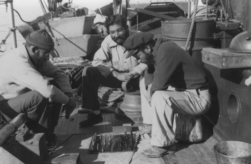 [Men playing chess on deck of R/V E.W. Scripps; Francisco Diaz, center]