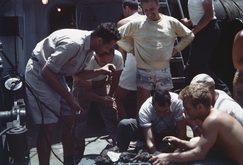 Scientists examine contents of dredge haul on deck of R/V HORIZON. Left to Right: Roger Revelle, Ed Hamilton, Robert Dietz, Ken Emery, Deane Carlson