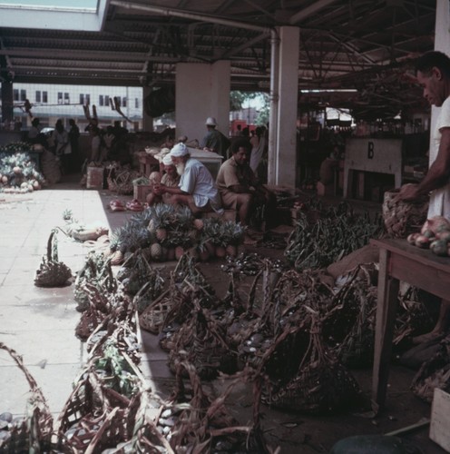 Men with baskets in a public market place in Suva, Fiji