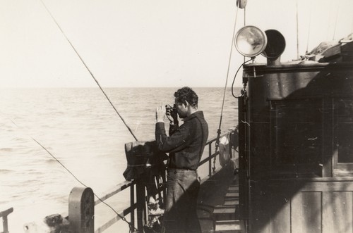 [Roger Revelle with sextant on R/V E.W. Scripps]